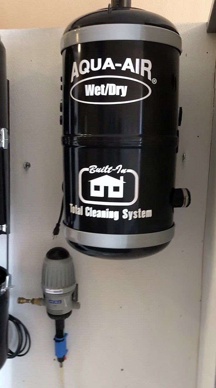 Black Aqua-Air wet/dry power unit mounted on a utility room wall