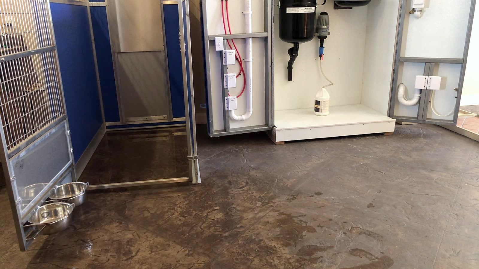 Kennel run with sealed floor and an Aqua-Air wet/dry cleaning station built into the wall